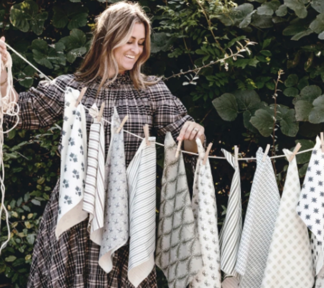 woman looking at clothes line of cloths hanging
