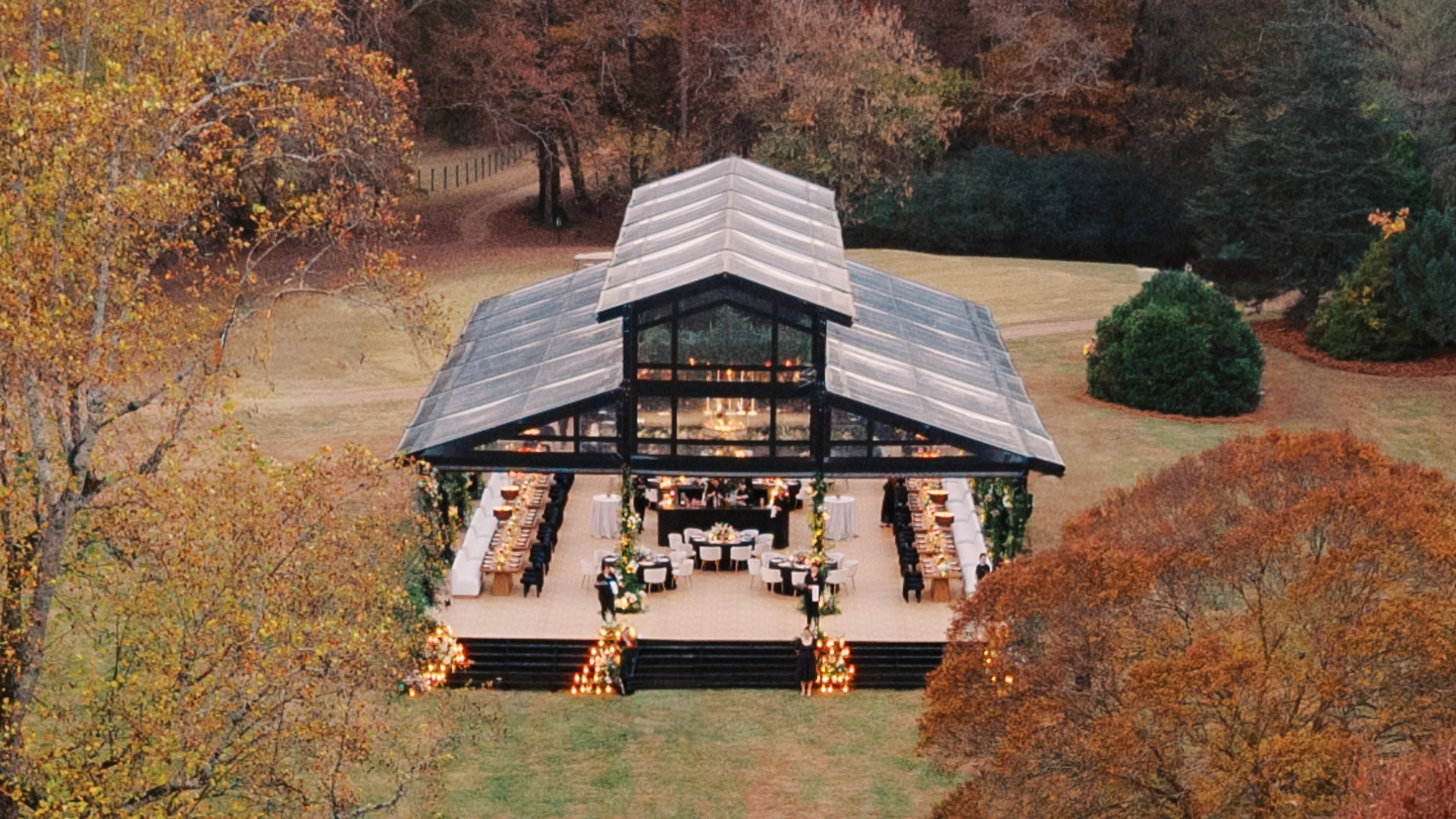 a large black glass tent in a field