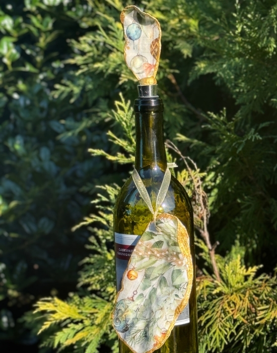 a wine bottle with a wine stopper and ornament hanging on it