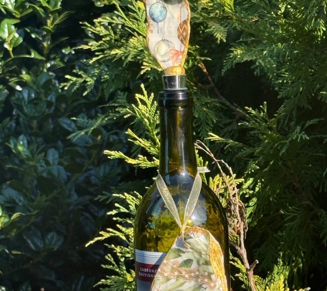 a wine bottle with a wine stopper and ornament hanging on it